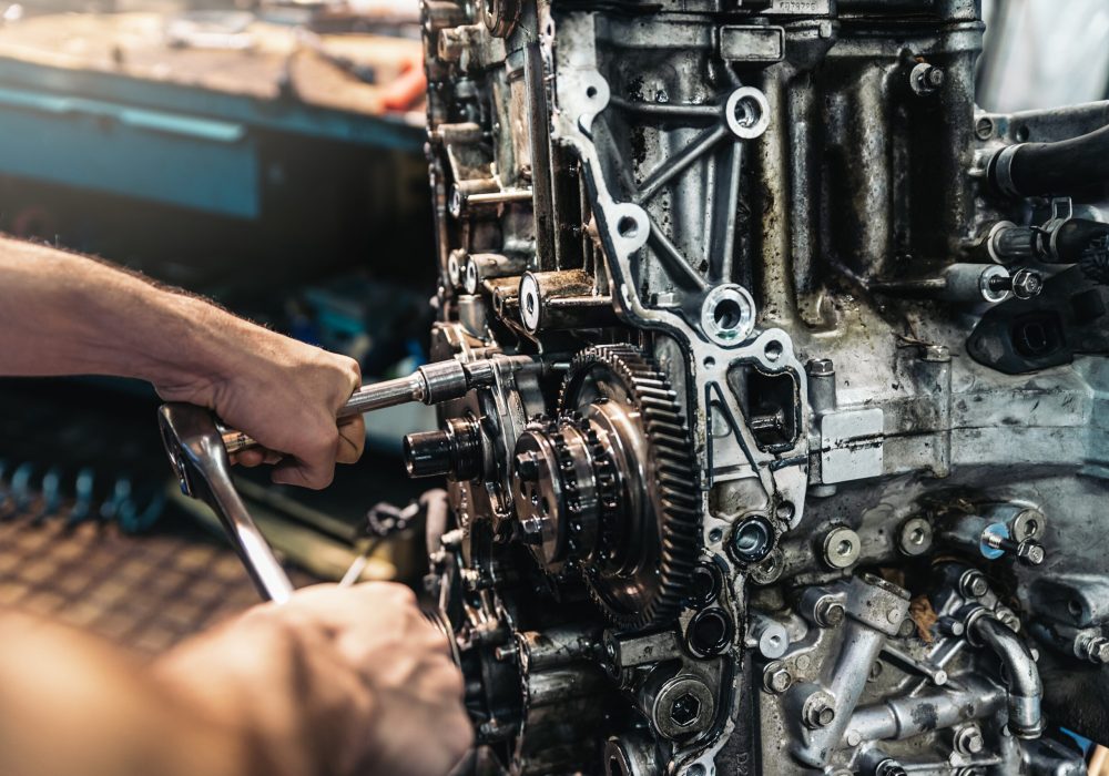 Professional Mechanic Repairing Car Engine in Garage.